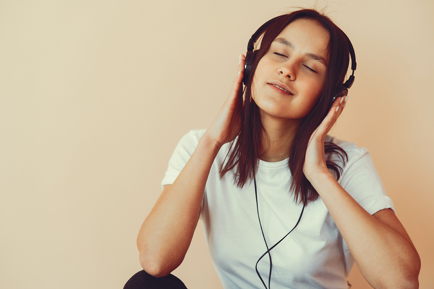 __woman smiling with headphones on and eyes closed